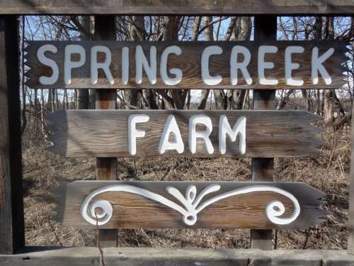 Welcoming sign for visitors at Spring Creek Farm in alaska