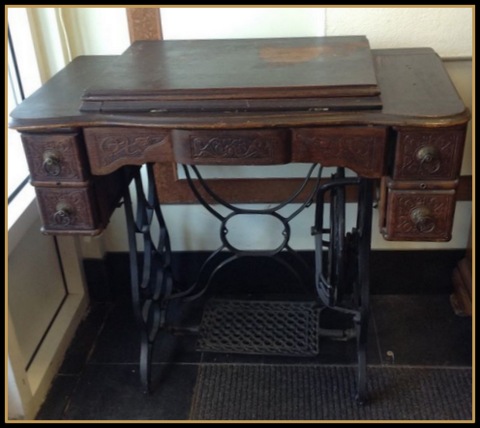 This was my first glimpse of the treadle machine, sitting by the window. dusty.