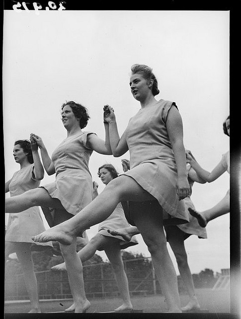 Female trainee physical education instructors performing leg swings, Hutt Valley, Wellington. March 1944