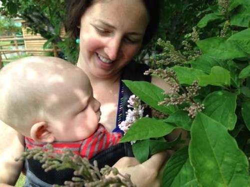 Rural towns leave space for beautiful plants.  Ava smells her first lilacs!