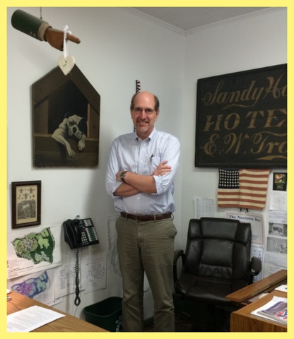 Editor Curtiss Clark in his office next to his favorite piece: a dog named "Spike". He likes his "Don't bother me demeanor." Spike's demeanor does NOT match that of Mr. Curtiss.