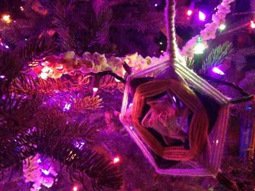 Popcorn garland and God's eye ornament on the tree.