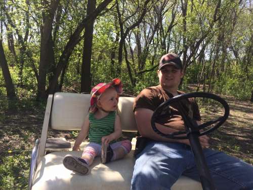 Home is where a golf cart ride is always waiting for you.  Ava and Uncle Marshall in NoDak!