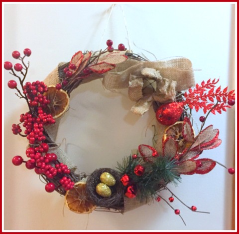 My dad taught me how to make wreaths from grapevine when I was a little girl. I made this one with dried fruit, burlap, and bling!