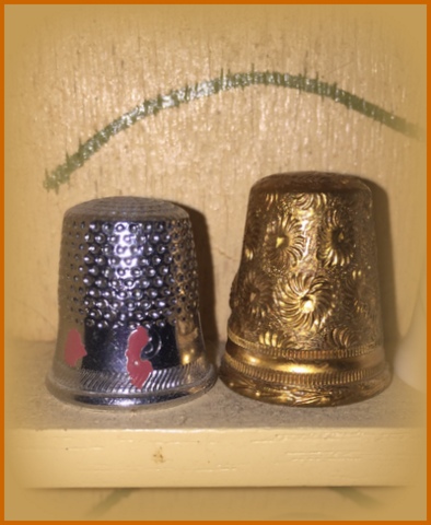 The thimble on the left is from my mom - it has her nail polish on it from when she was in high school home ec. class in the 50's! The one on the left we picked up in the 70's in New Braunfels, TX at a German restaurant/gift shop. 