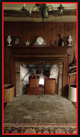 Flea market vintage baskets and back lighting warm up this fireplace in summer.