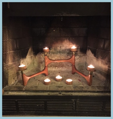 I found this old Danish teak candelabra in a thrift shop. I remove the grate and add tea lights to my fireplace in my family room in summer...