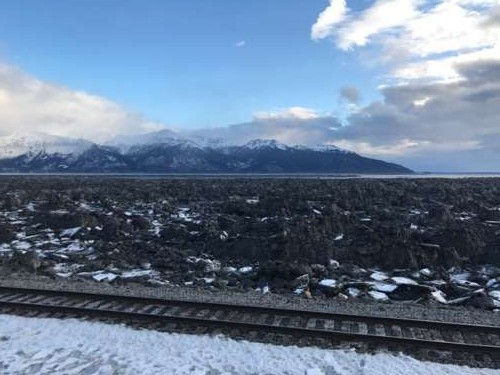 View of the Cook Inlet from a roadside stop south of Anchorage, AK.  All of those black lumps are ice bergs that have been left behind after the tide goes out.  Soon we will see only mud flats at low tide instead of this bizarre moonscape.  Spring is coming!