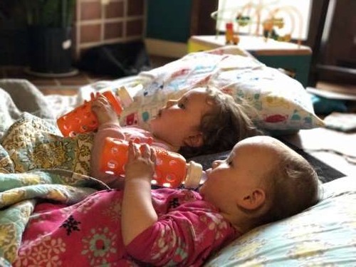 Keeping kids entertained with movies, baby bottles of water and a floor nest.  Living the dream.