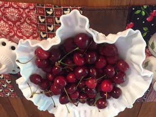 Sweet red cherries in white milk glass scream "Summer's here!"