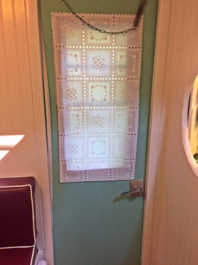 We needed privacy but didn't want to drill holes. I could not find fabric to match the curtains, so I found this vinyl paneled 'fabric' and cut it to fit, using Gorilla tape to hang. The whole thing cost me $5.00, and I think it goes well with the curtains. 