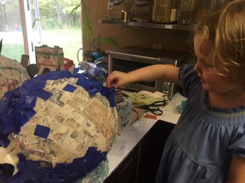 Ava helping me make the blueberry piñata. 