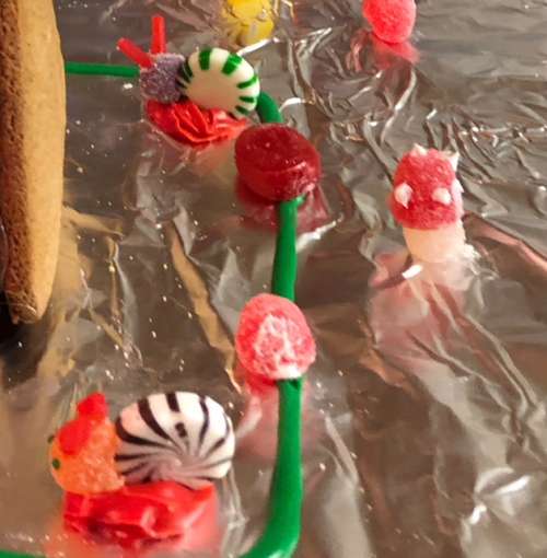 Nature-inspired additions to Opal's gingerbread house: Snails and a mushroom.  