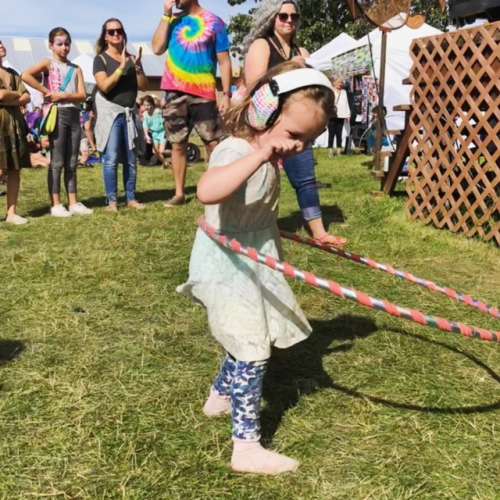 Noise canceling headphones are another option to ensure isolation if hoods and rain aren't abundant.  This is Ava at a music festival a few weeks ago. She's a hula hooping pro!