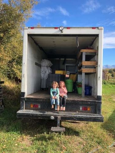 Listening to stories in the back of the box truck while I clean veggies.