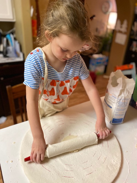 Ava rolling out lefse.