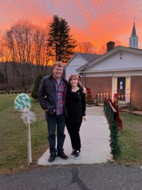 My daughter snapped this photo of us at the entrance to the church where the Gingerbead Village is displayed. Check out that December sky!