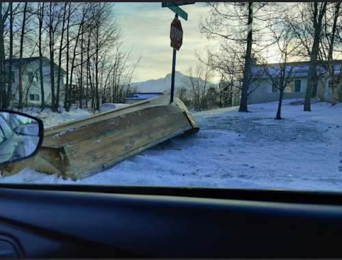 Boat caught on a street sign