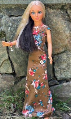 This doll did not have clothes, and originally came in a gold lame swimsuit in the 1970s. This dress came from Etsy. 