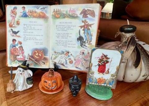 A vintage 40’s Childcraft book shows the lighter side of Halloween. Small pieces including a 1910 postcard and a small candy holder from the 70’s are spooky without gore of many modern decorations. 